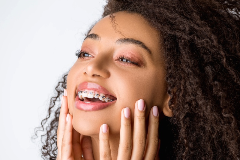 Happy patient with braces smiling confidently after orthodontic treatment in Getzville